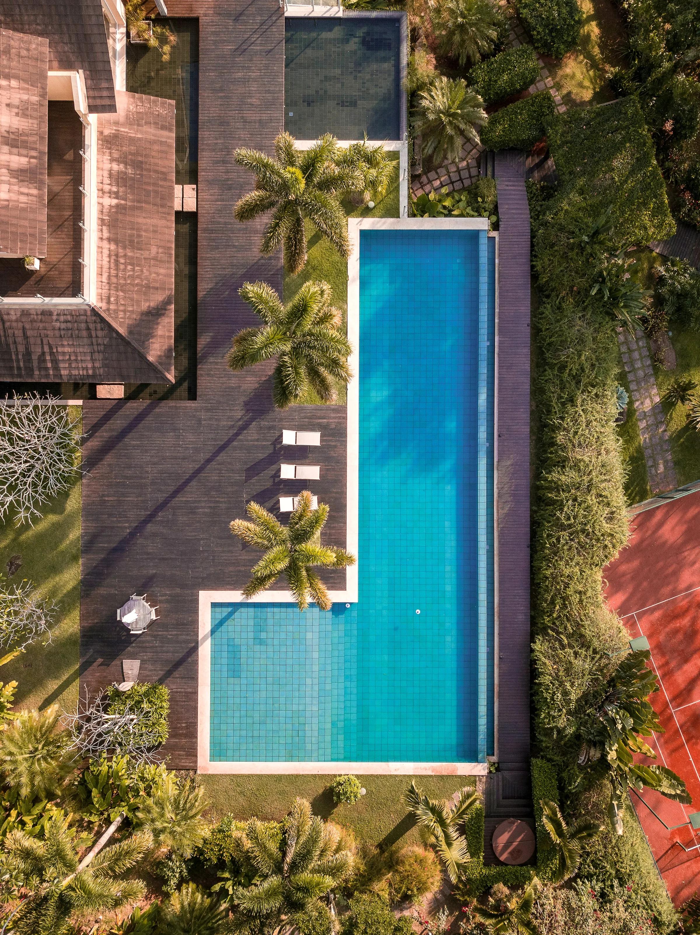 Aerial view of a luxury villa with a long infinity pool