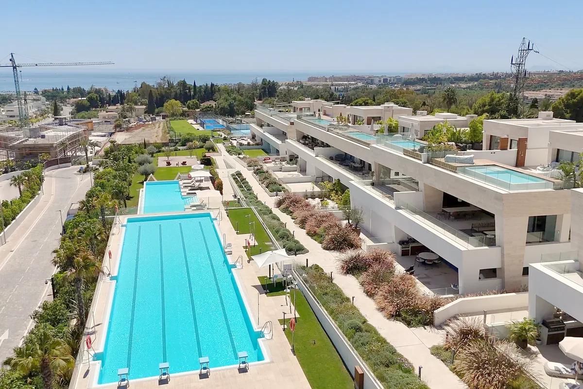 New apartment buildings with a long pool, with more construction nearby