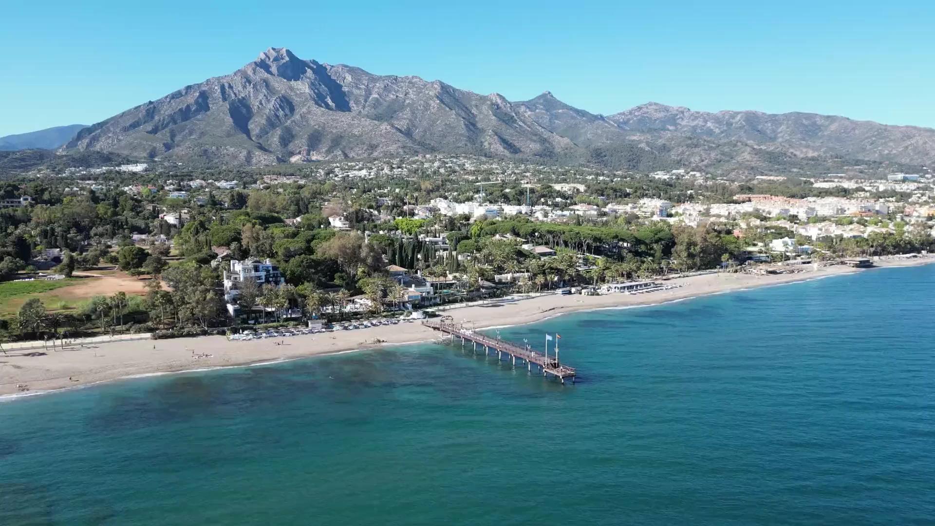 The Marbella coastline with its beach, pier and La Concha mountain