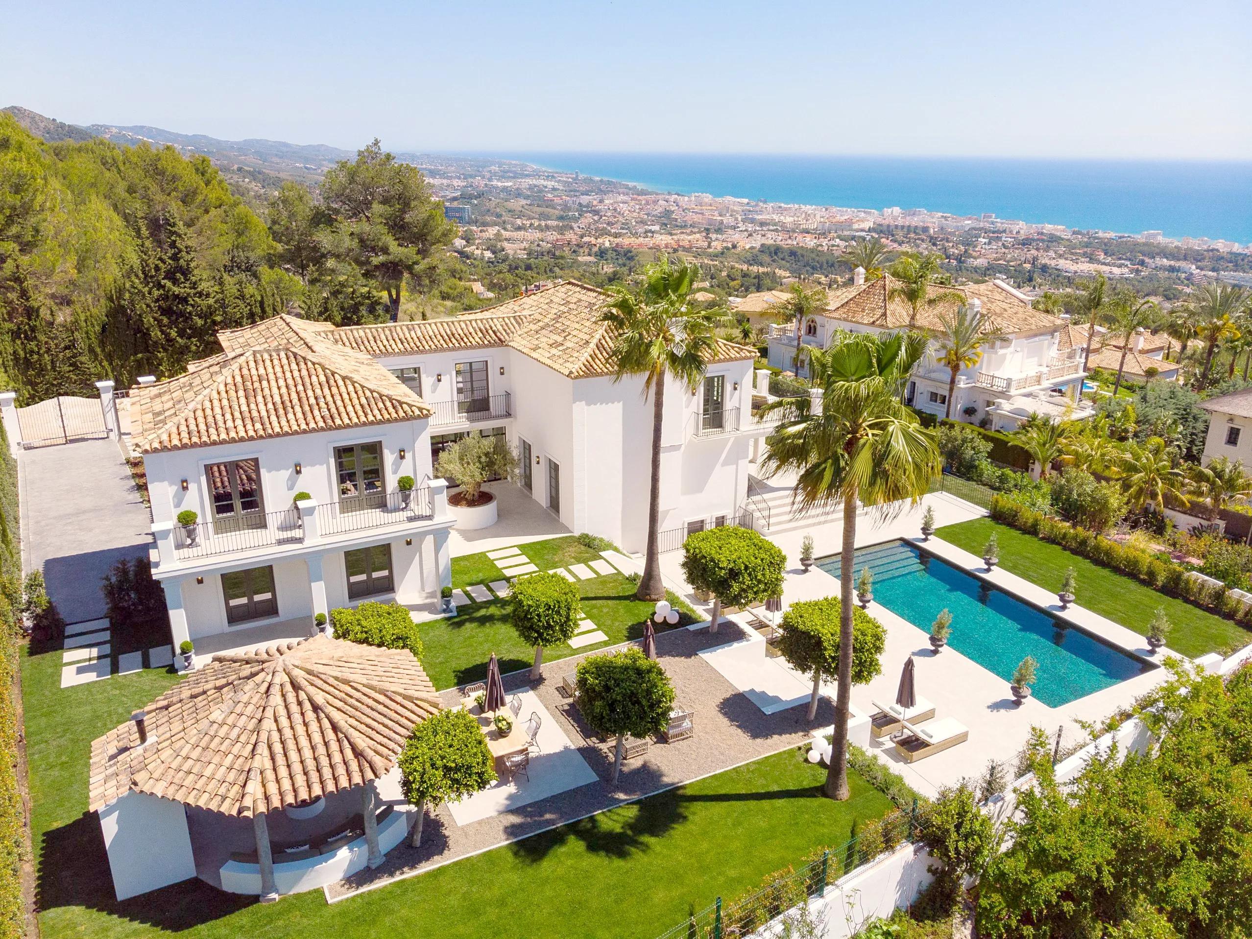 White villa with a pool and garden above Marbella overlooking the sea